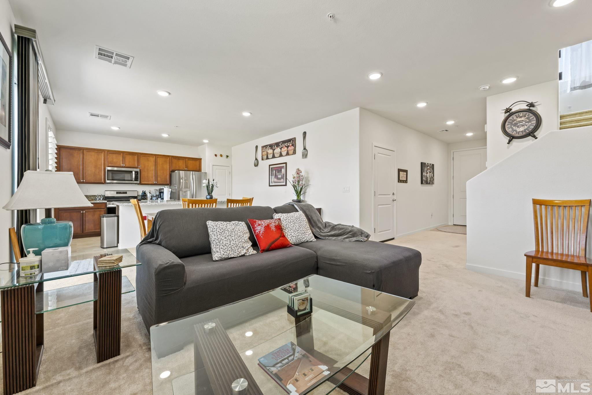 4928 Black Falcon Way Sun Valley, NV 89433 - Photo 8 of 32 a living room with furniture and a large window