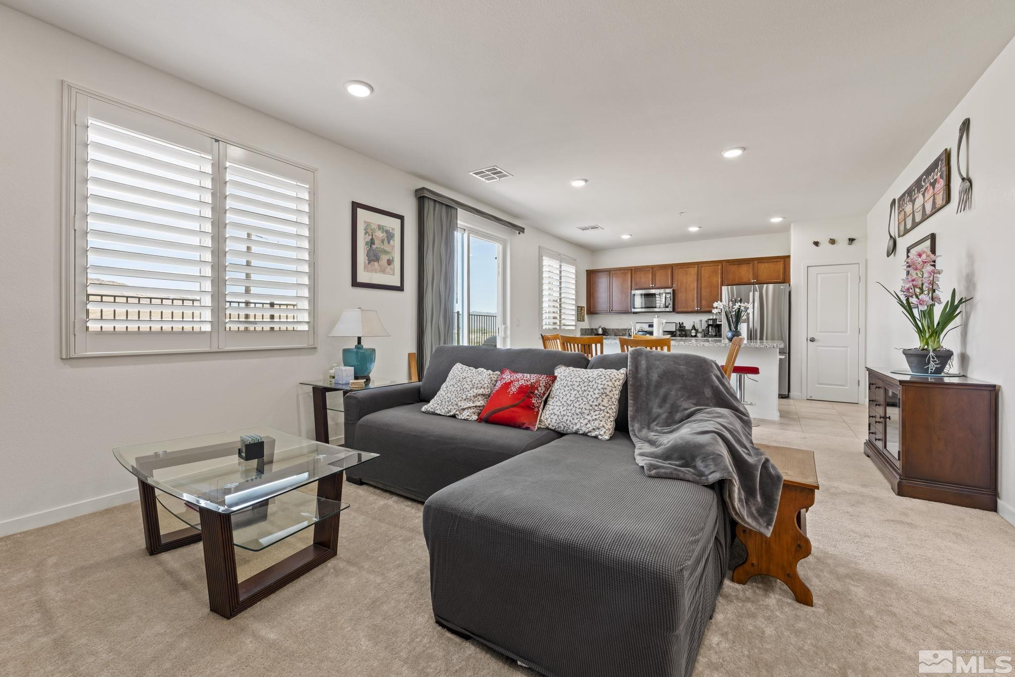 4928 Black Falcon Way Sun Valley, NV 89433 - Photo 10 of 32 a living room with furniture and a window