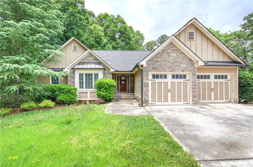 561 Holland Road Dallas, GA 30157 - Photo 3 of 48 a front view of a house with a yard and potted plants