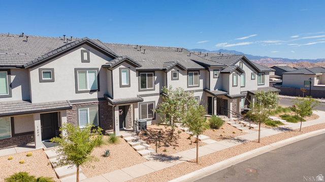1693 Devils Gdn Lane Washington, UT 84780 - Photo 3 of 64 Multi-level townhome featuring a stucco exterior with stone accents and dark trim