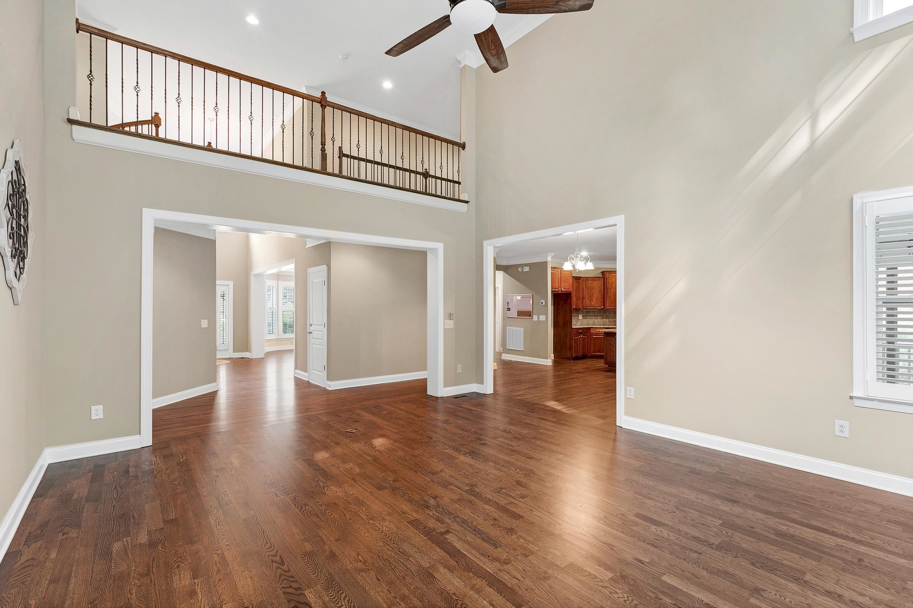 8431 Henderson Road Apex, NC 27539 - Photo 12 of 56 a view of livingroom with hardwood floor and a ceiling fan
