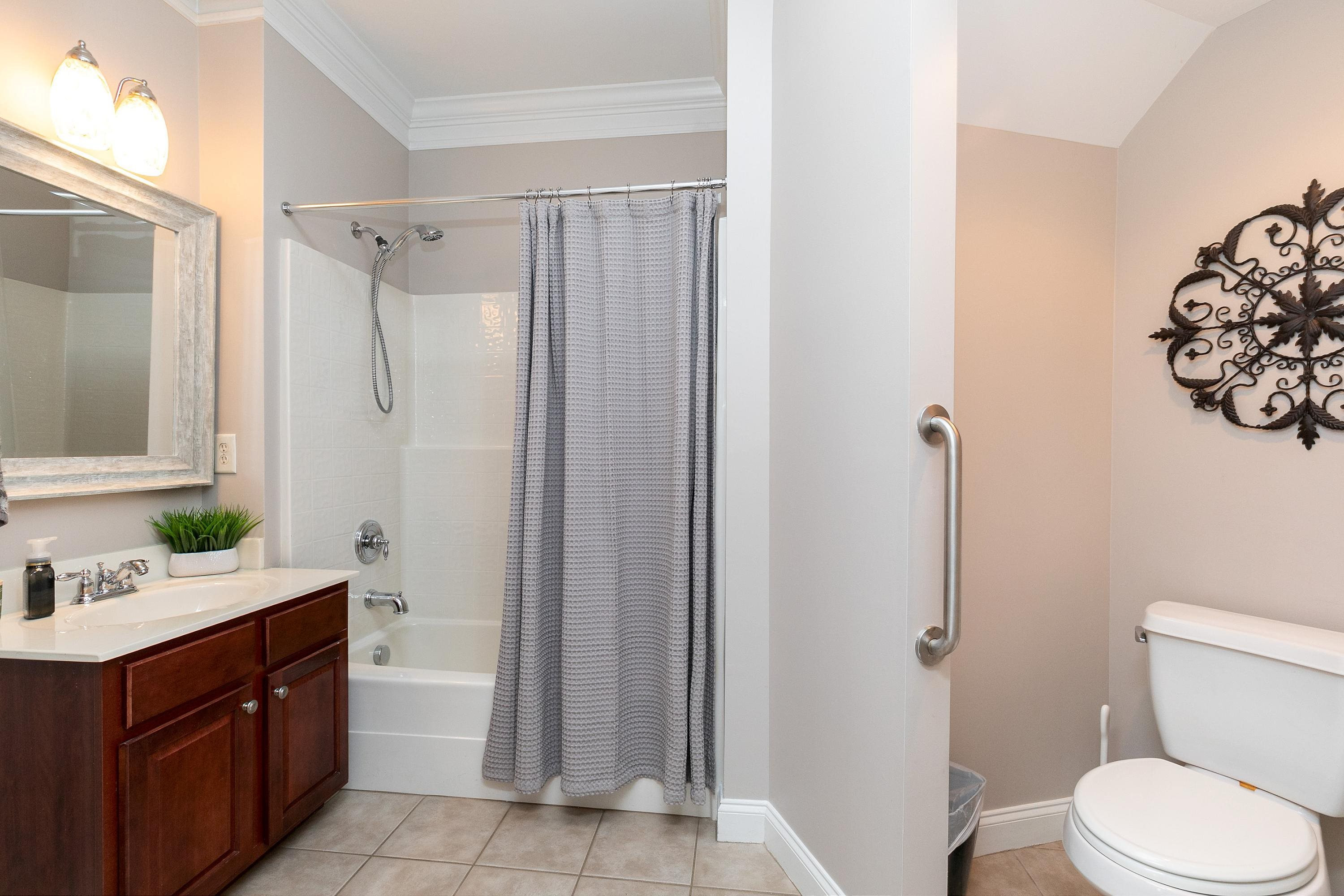 8431 Henderson Road Apex, NC 27539 - Photo 14 of 56 a bathroom with a sink a toilet and shower