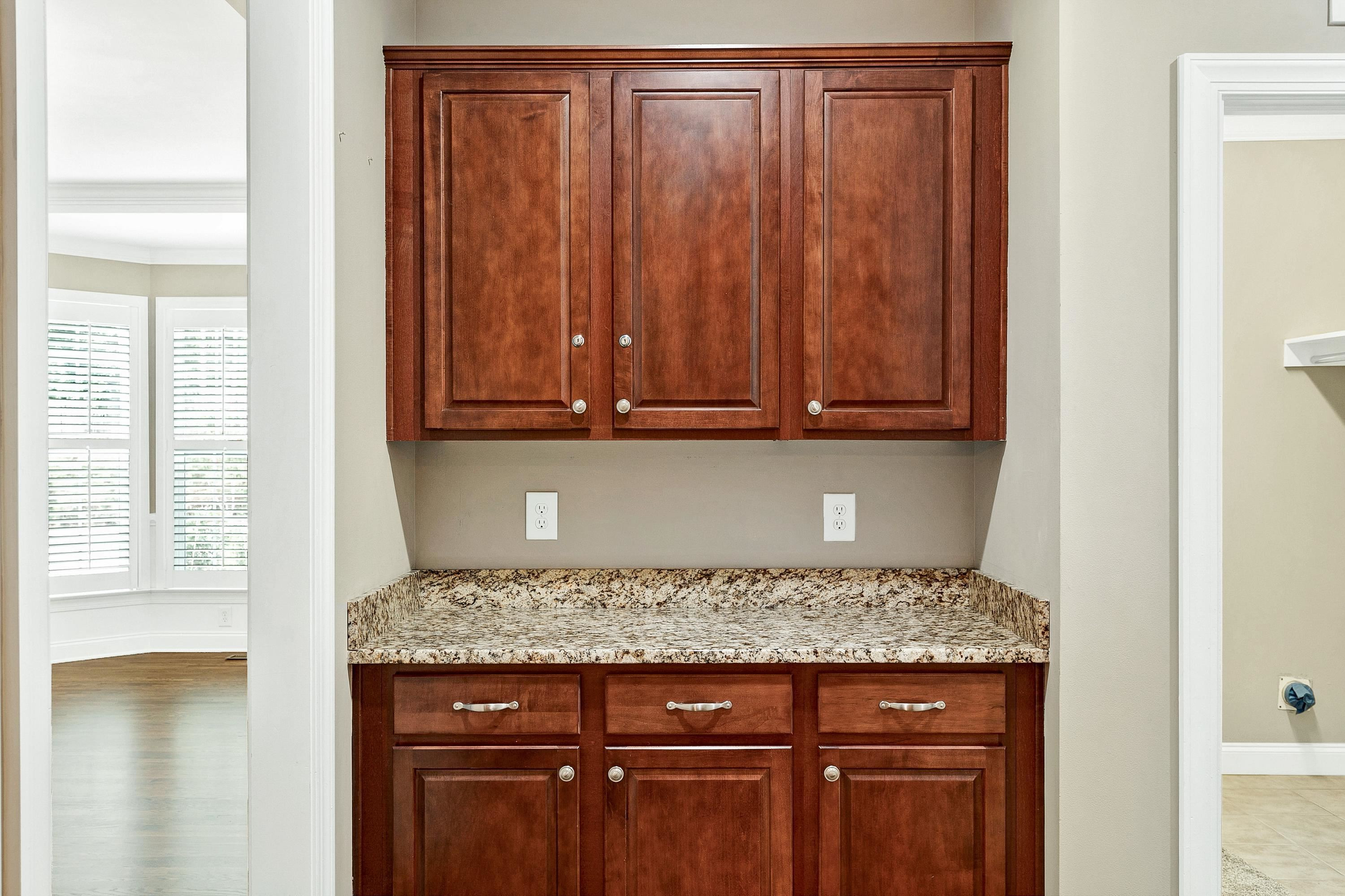 8431 Henderson Road Apex, NC 27539 - Photo 18 of 56 a view of a storage and utility room with granite countertop cabinets