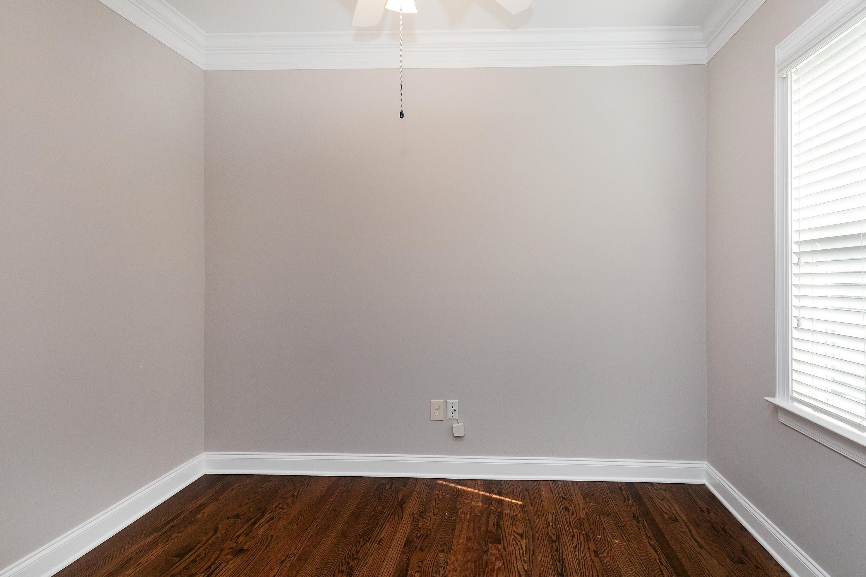 8431 Henderson Road Apex, NC 27539 - Photo 19 of 56 a view of an empty room with wooden floor and a window