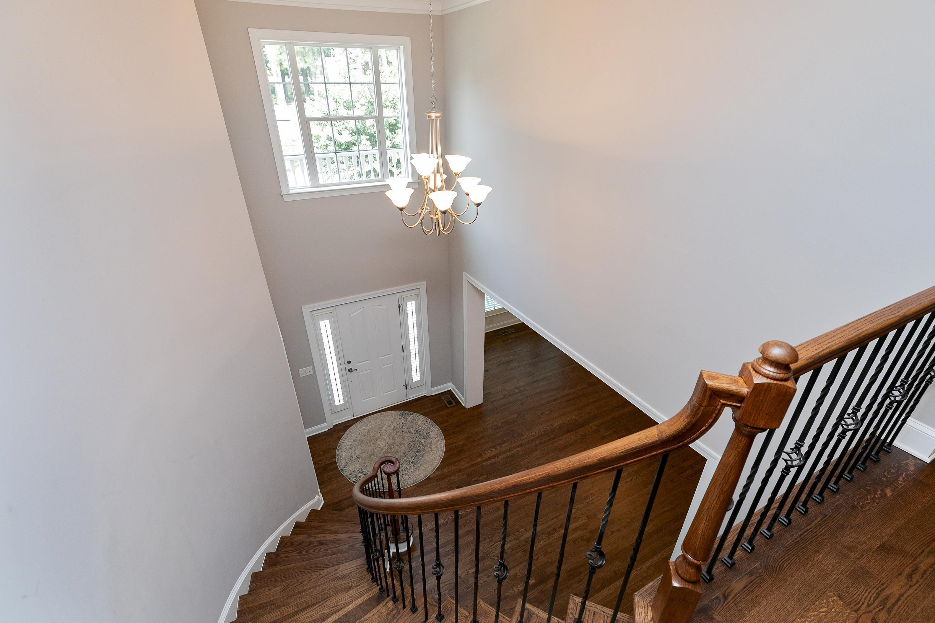 8431 Henderson Road Apex, NC 27539 - Photo 23 of 56 a view of entryway and hall with wooden floor