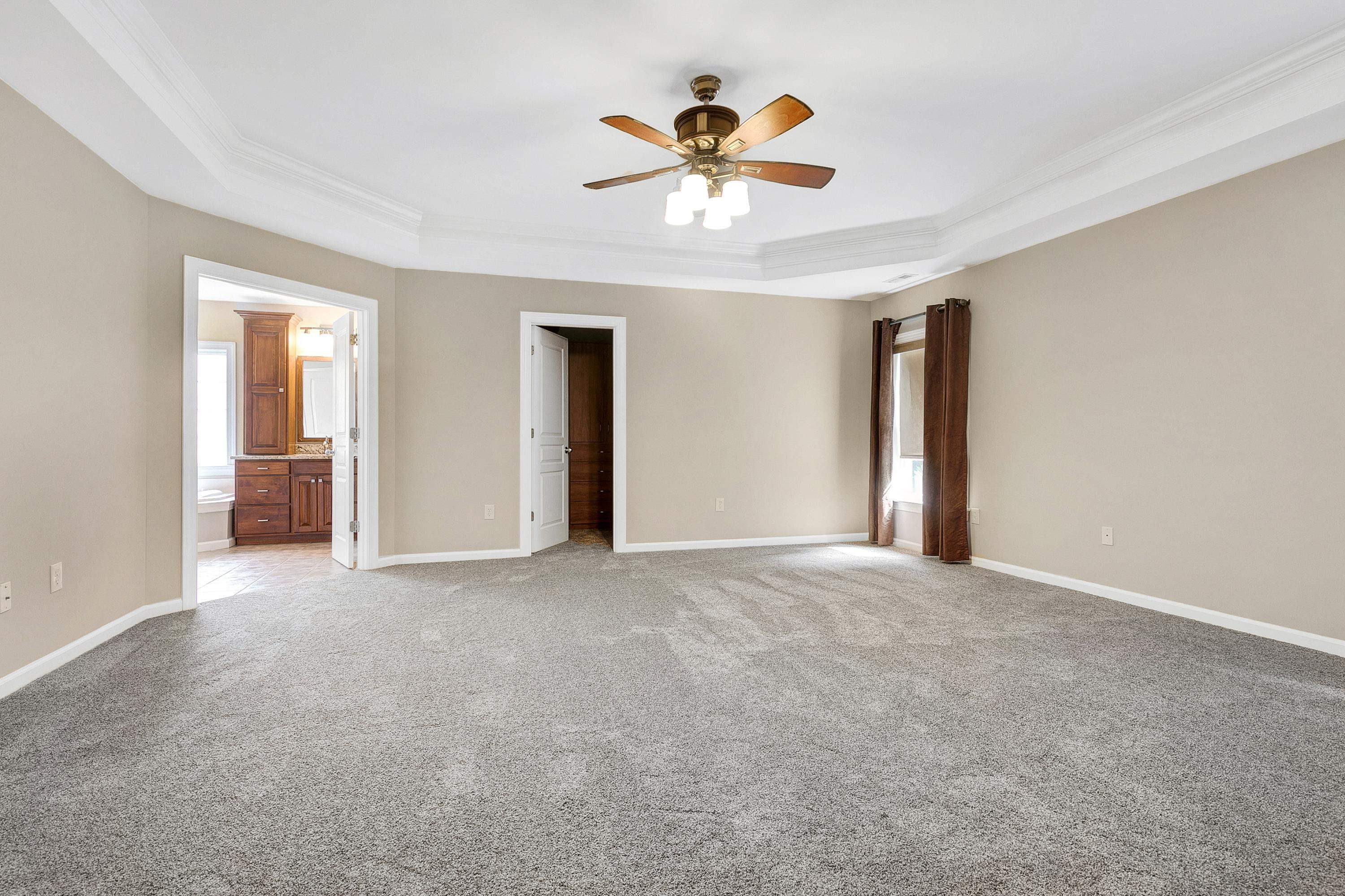 8431 Henderson Road Apex, NC 27539 - Photo 26 of 56 a view of an empty room with a ceiling fan