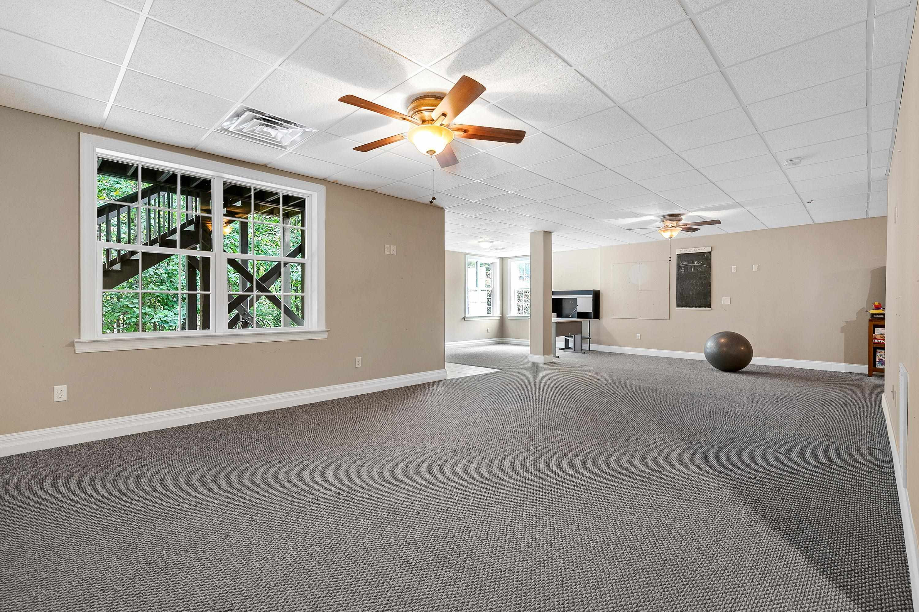 8431 Henderson Road Apex, NC 27539 - Photo 39 of 56 a view of a livingroom with a ceiling fan and window