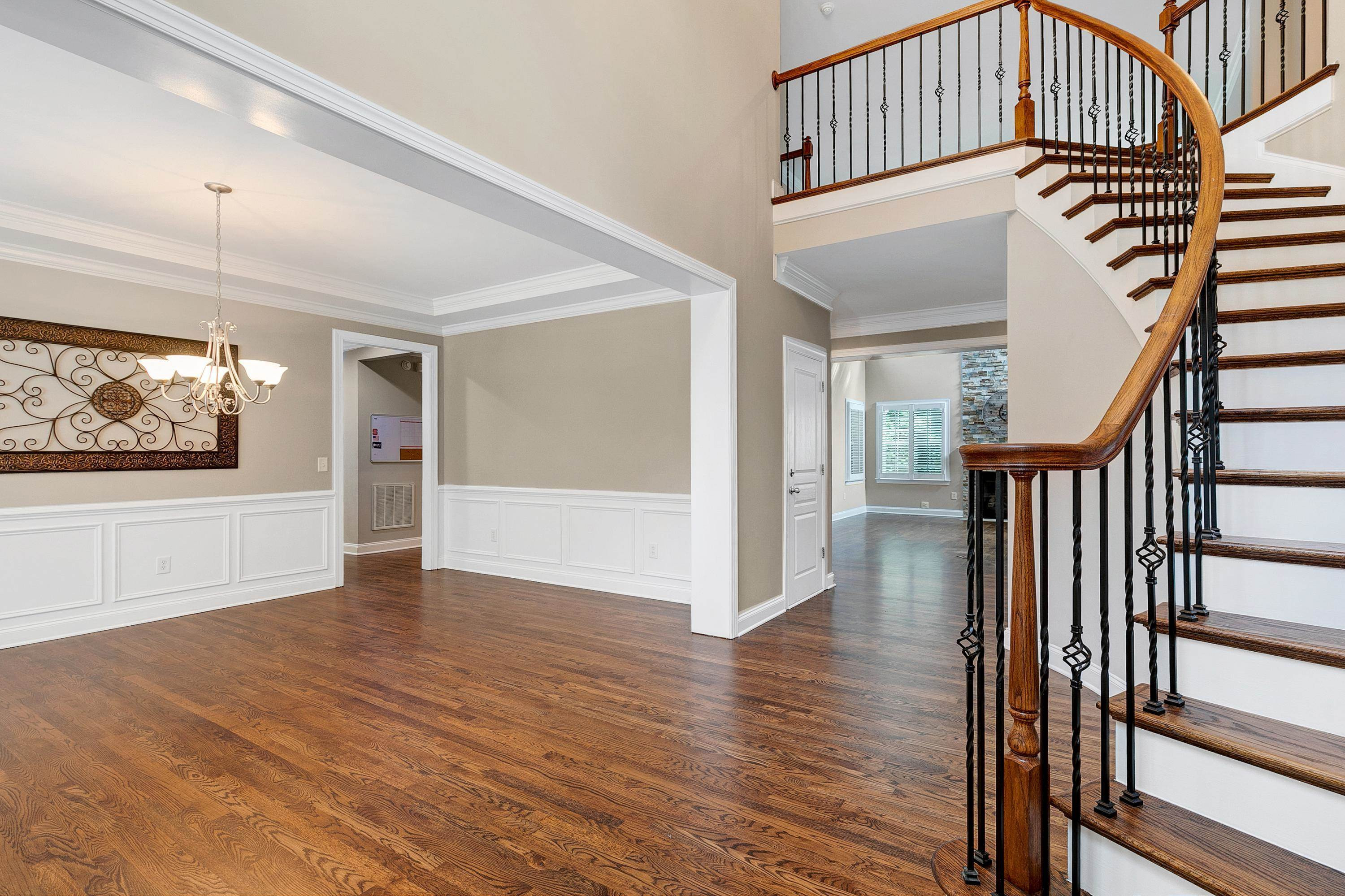 8431 Henderson Road Apex, NC 27539 - Photo 5 of 56 a view interior of a house with wooden floor windows and a ceiling fan