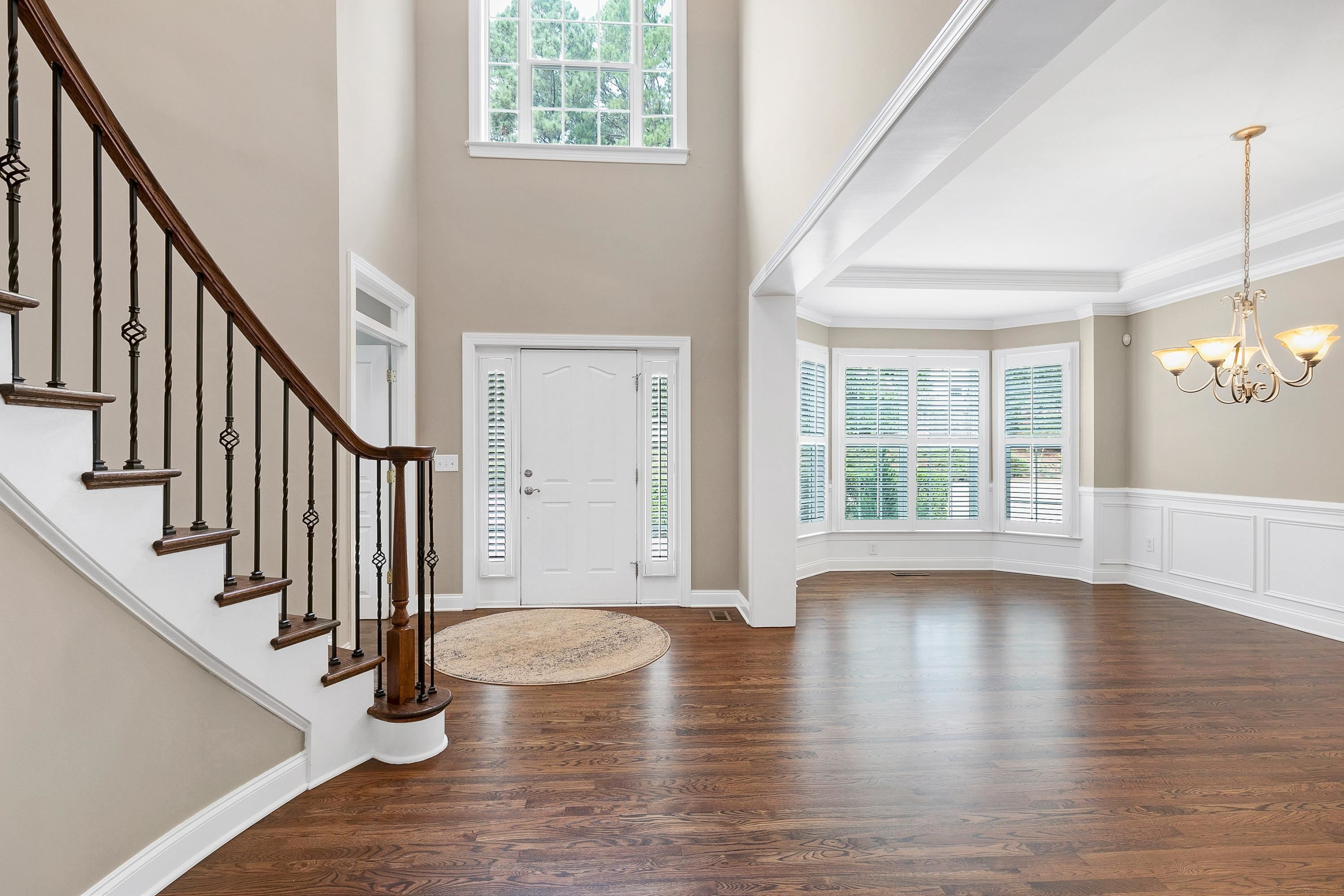 8431 Henderson Road Apex, NC 27539 - Photo 10 of 56 a view of an entryway with wooden floor and staircase