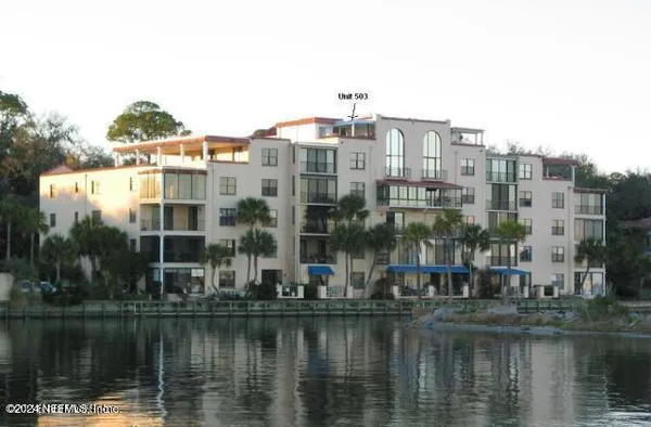 a view of a lake with a city skyline in the background