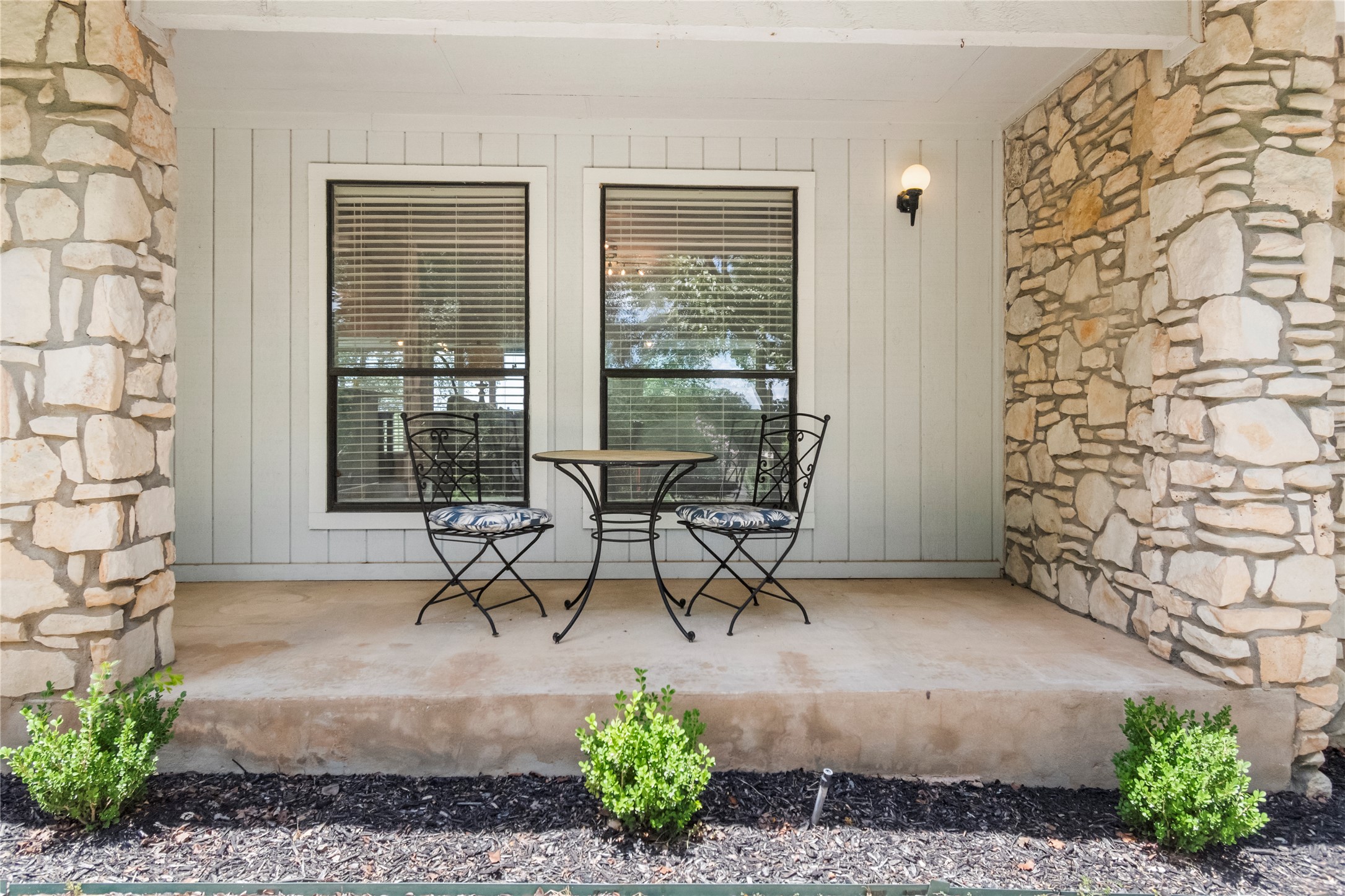 210 Teeoff, Unit B Horseshoe Bay, TX 78657 - Photo 7 of 38 A welcoming front porch features stone columns and a tranquil sitting area.