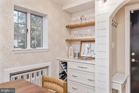 a kitchen with stainless steel appliances a stove a sink a microwave a counter and a refrigerator