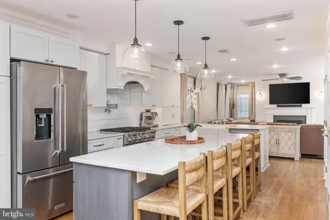 a stove top oven sitting inside of a kitchen