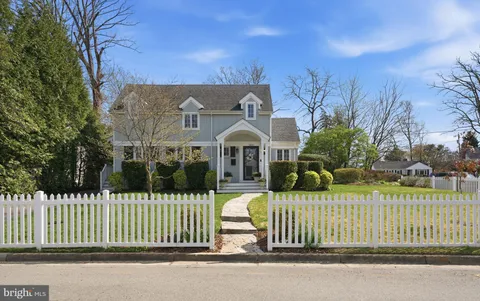 a front view of a house with a garden and plants