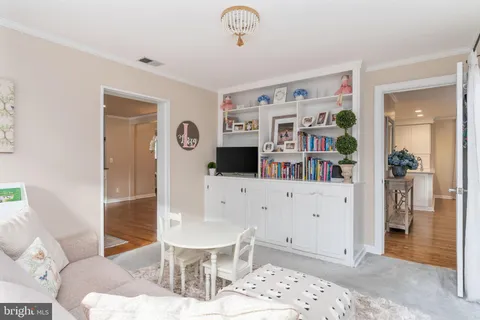a spacious bedroom with a bed and a chandelier