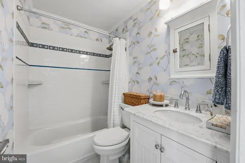 a bathroom with double sink and a mirror