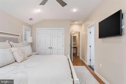 a bedroom with a bed and a flat screen tv