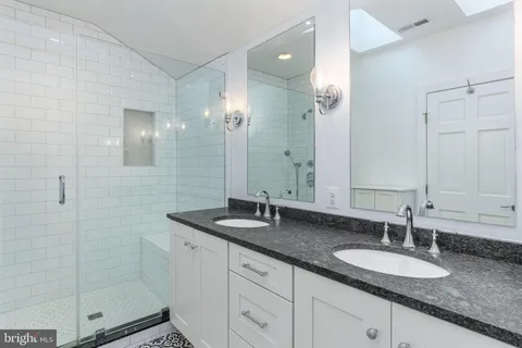 a bedroom with a bed and a large mirror