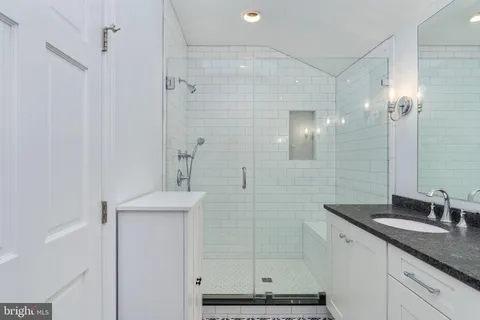 a bathroom with a toilet sink shower and mirror