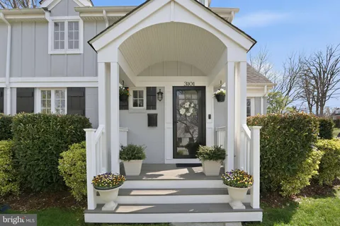 a front view of a house with plants