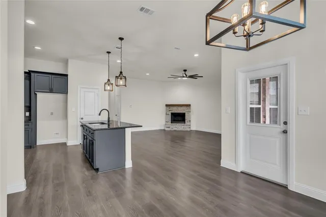 a view of a kitchen with sink and cabinet