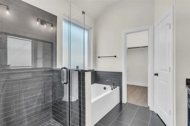 a bathroom with a bathtub and a shower