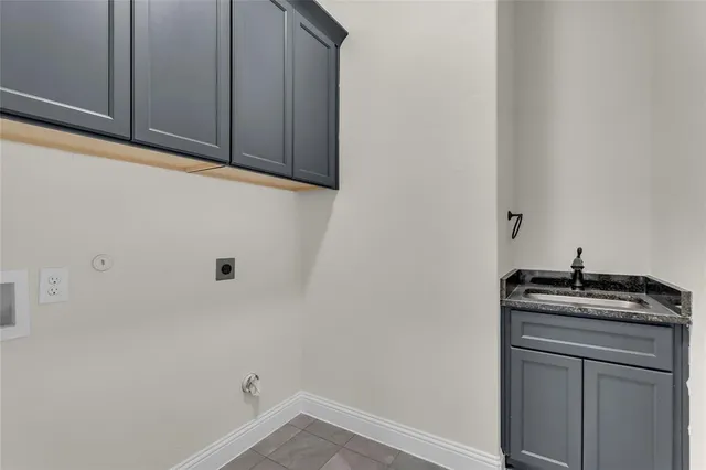 a bathroom with a granite countertop sink and cabinets