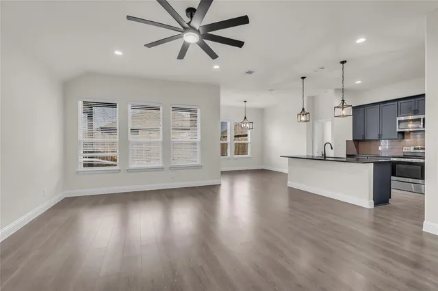 a view of a kitchen with a sink and a window
