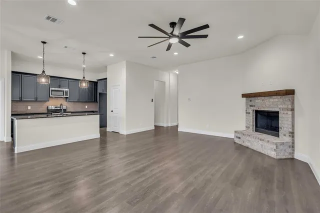 a view of kitchen with sink microwave and refrigerator