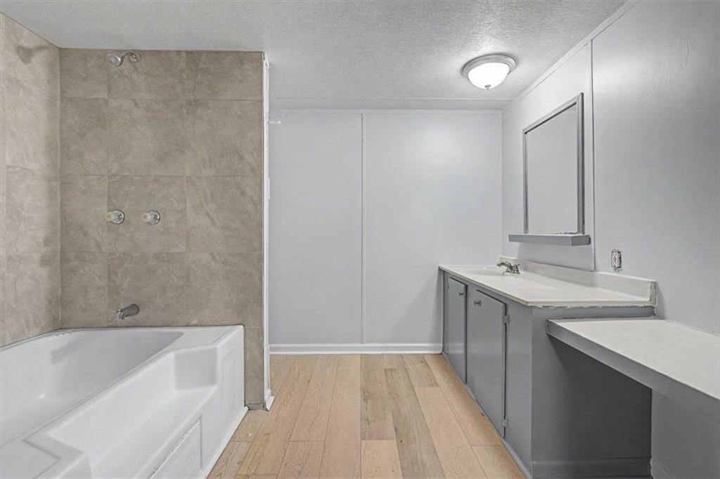 360 Black Knob Church Road Ranger, GA 30734 - Photo 13 of 20 a bathroom with a tub sink and mirror