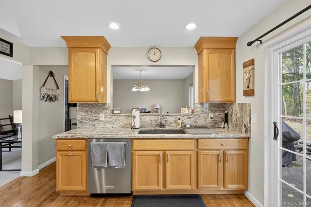 a spacious bathroom with a granite countertop sink and a mirror