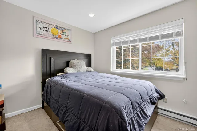 a spacious bedroom with a bed and a dresser