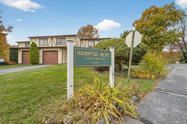 a view of a lake with a big yard and potted plants and large trees