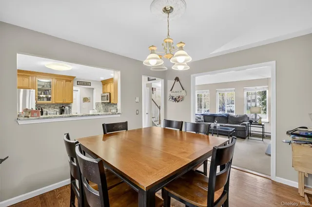 a living room with furniture a fireplace and a floor to ceiling window