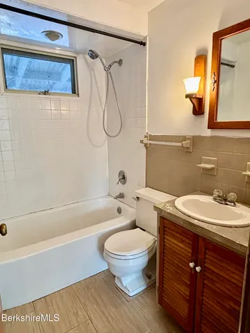 a bathroom with a sink a toilet and a bathtub