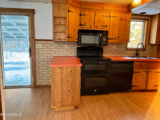 a kitchen with wooden floors and a sink