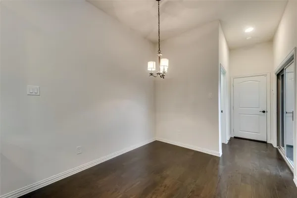 a view of a room with wooden floor fan and window