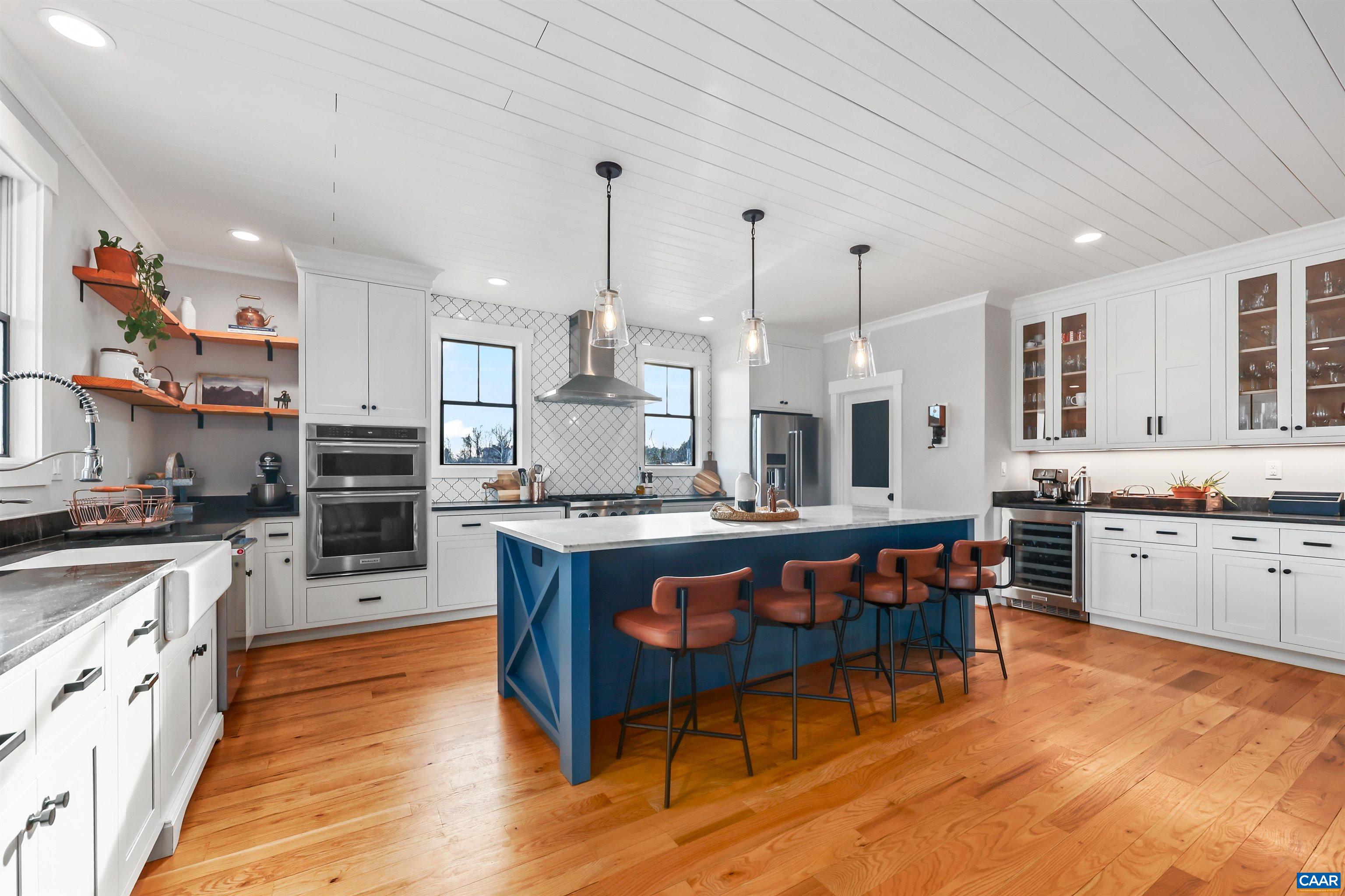 5797 Advance Mills Road Advance Mills, VA 22968 - Photo 17 of 70 a large kitchen with stainless steel appliances kitchen island granite countertop a stove a sink a dining table and chairs