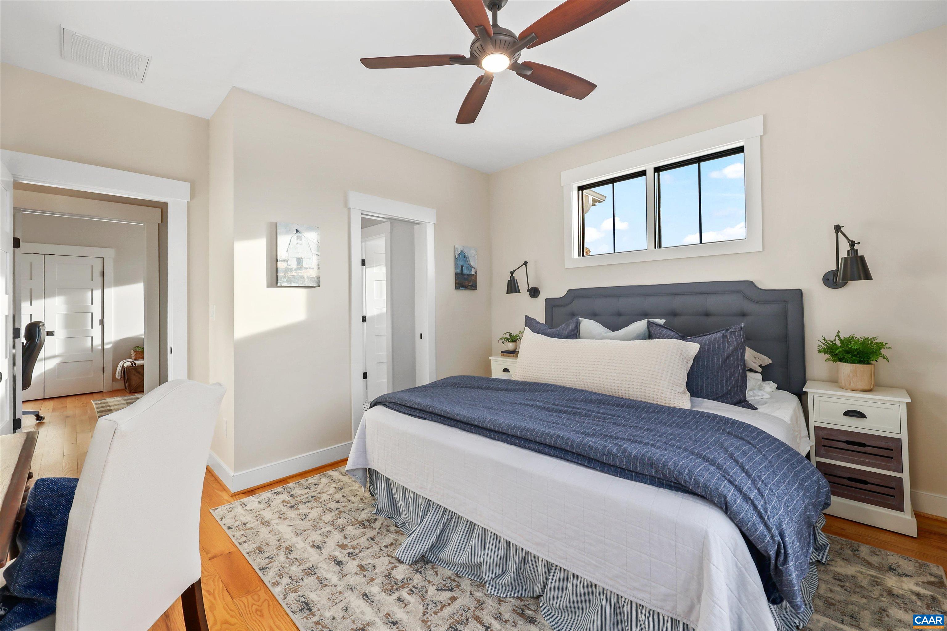5797 Advance Mills Road Advance Mills, VA 22968 - Photo 28 of 70 a bedroom with a large bed and a chandelier