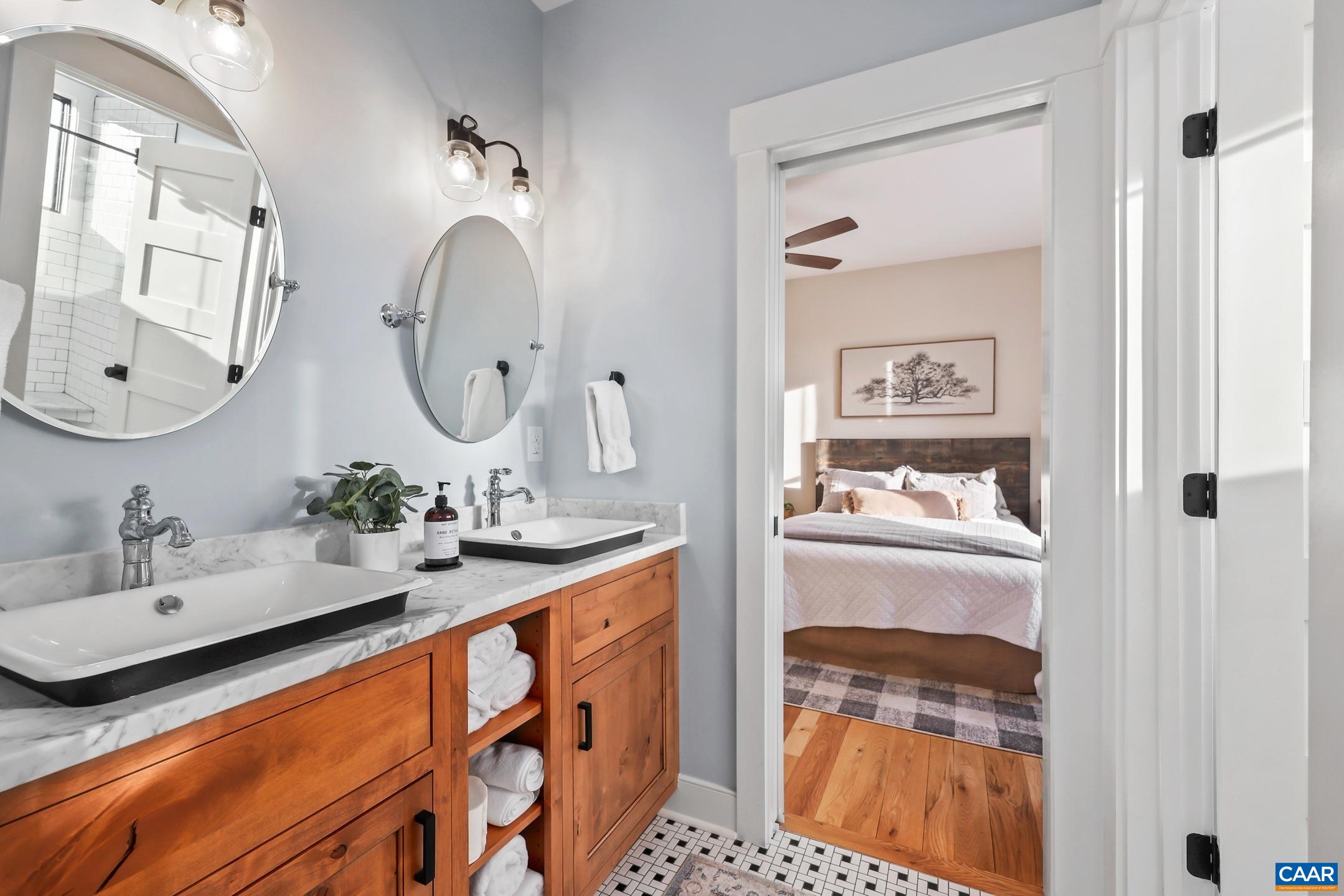 5797 Advance Mills Road Advance Mills, VA 22968 - Photo 31 of 70 a en suite bathroom with a double vanity sink and a mirror