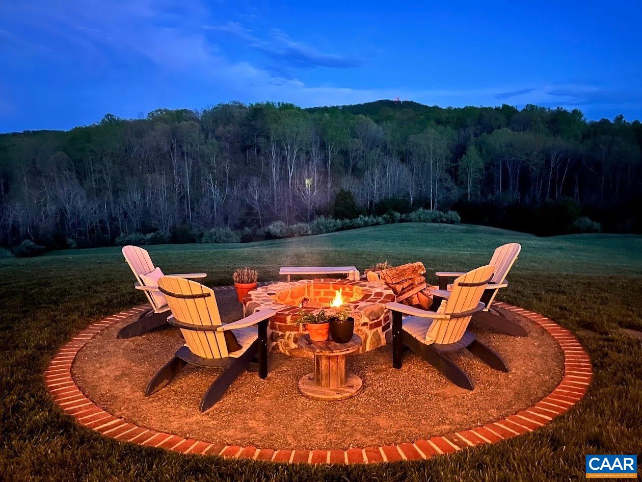 5797 Advance Mills Road Advance Mills, VA 22968 - Photo 57 of 70 a backyard of a house with table and chairs