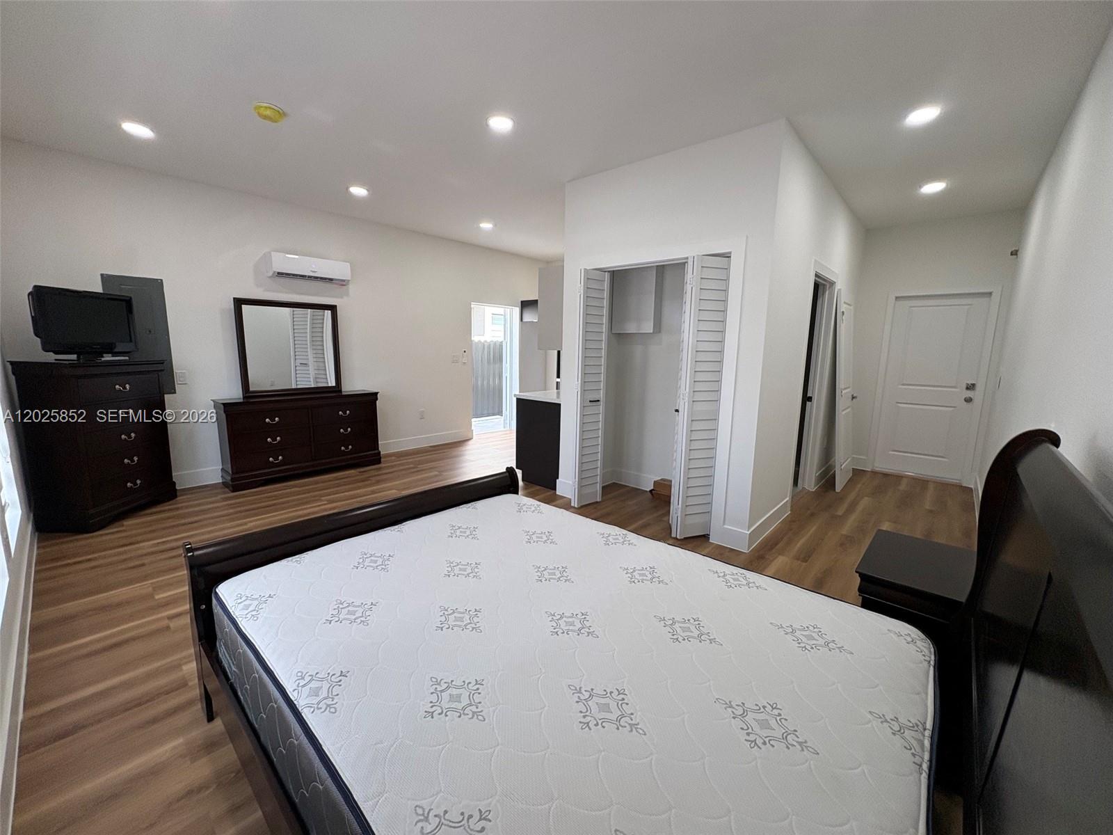 12948 Southwest 265th Terrace, Unit STUDIO Homestead, FL 33032 - Photo 12 of 16 a living room with furniture and a flat screen tv