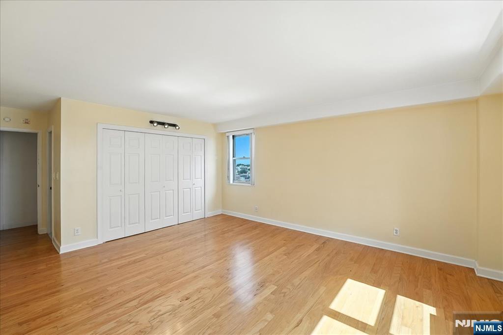 6600 JFK Boulevard East, Unit 18L West New York, NJ 07093 - Photo 19 of 36 a view of an empty room with wooden floor and a window