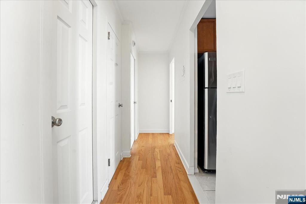 6600 JFK Boulevard East, Unit 18L West New York, NJ 07093 - Photo 21 of 36 a view of a hallway with wooden floor