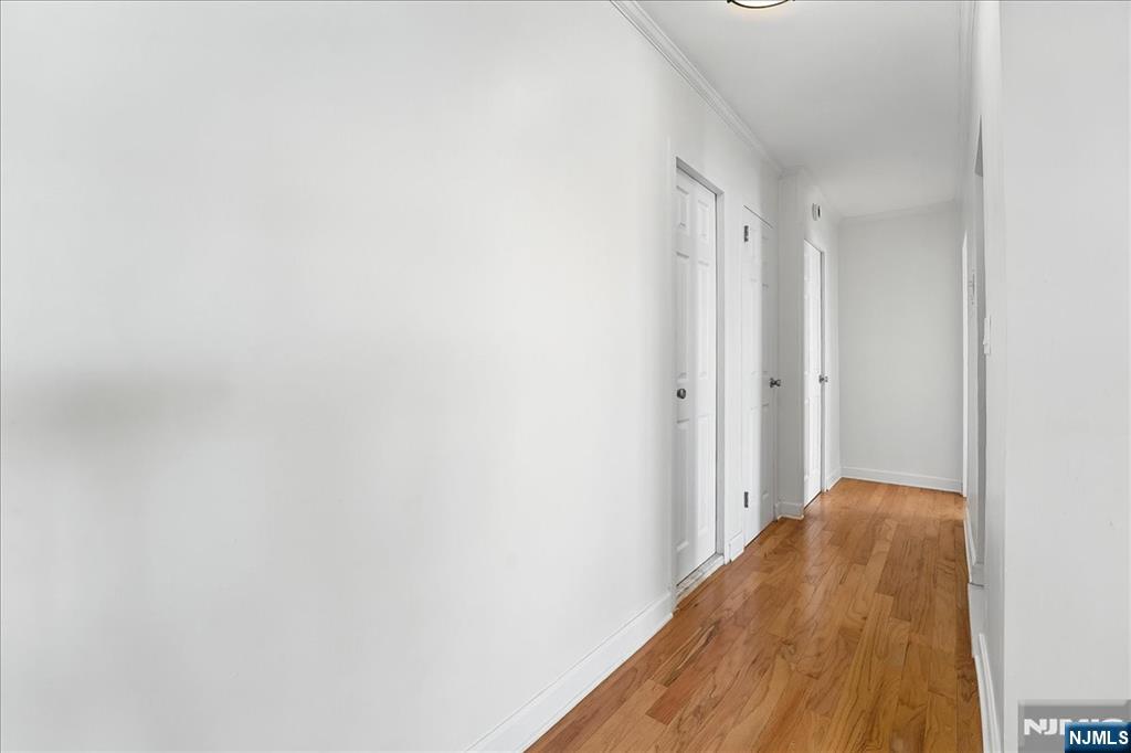 6600 JFK Boulevard East, Unit 18L West New York, NJ 07093 - Photo 22 of 36 a view of a room with wooden floor