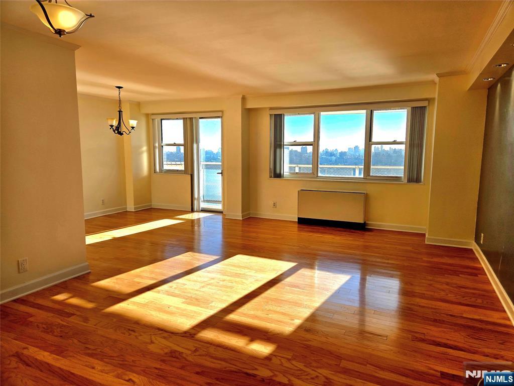 6600 JFK Boulevard East, Unit 18L West New York, NJ 07093 - Photo 3 of 36 a spacious bedroom with a bed and wooden floor