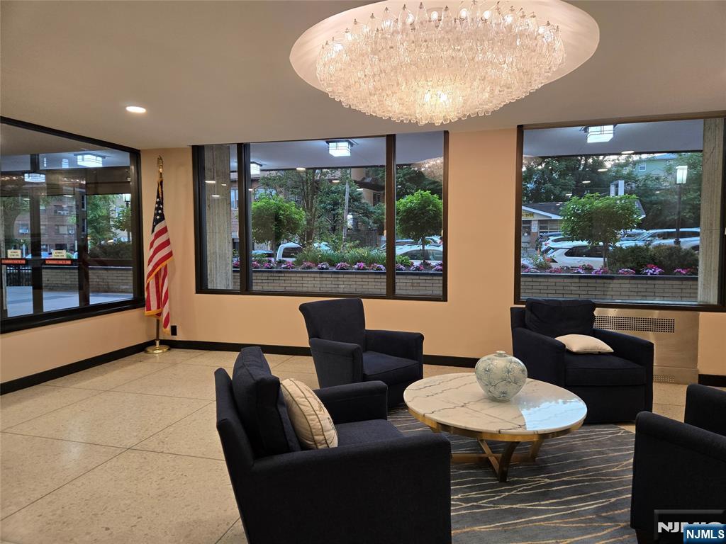 6600 JFK Boulevard East, Unit 18L West New York, NJ 07093 - Photo 32 of 36 a living room with furniture and a large window
