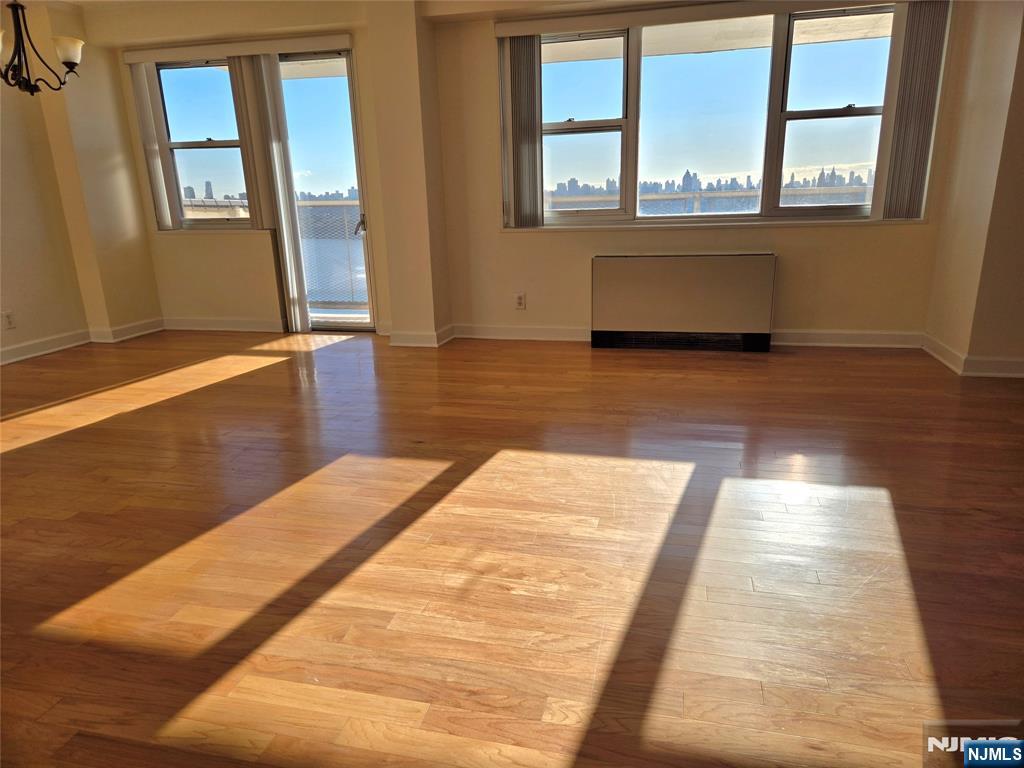 6600 JFK Boulevard East, Unit 18L West New York, NJ 07093 - Photo 35 of 36 a view of an empty room with wooden floor and a window