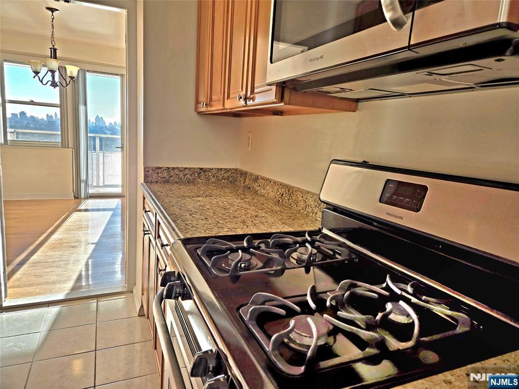 6600 JFK Boulevard East, Unit 18L West New York, NJ 07093 - Photo 36 of 36 a stove top oven sitting inside of a kitchen