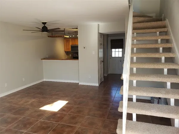 a view of a hallway with wooden floor and entryway